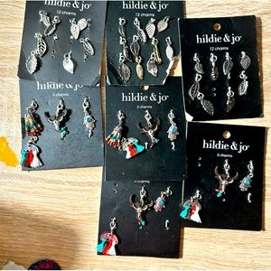 7 charm sets. 3 same and 4 the same. Some missing